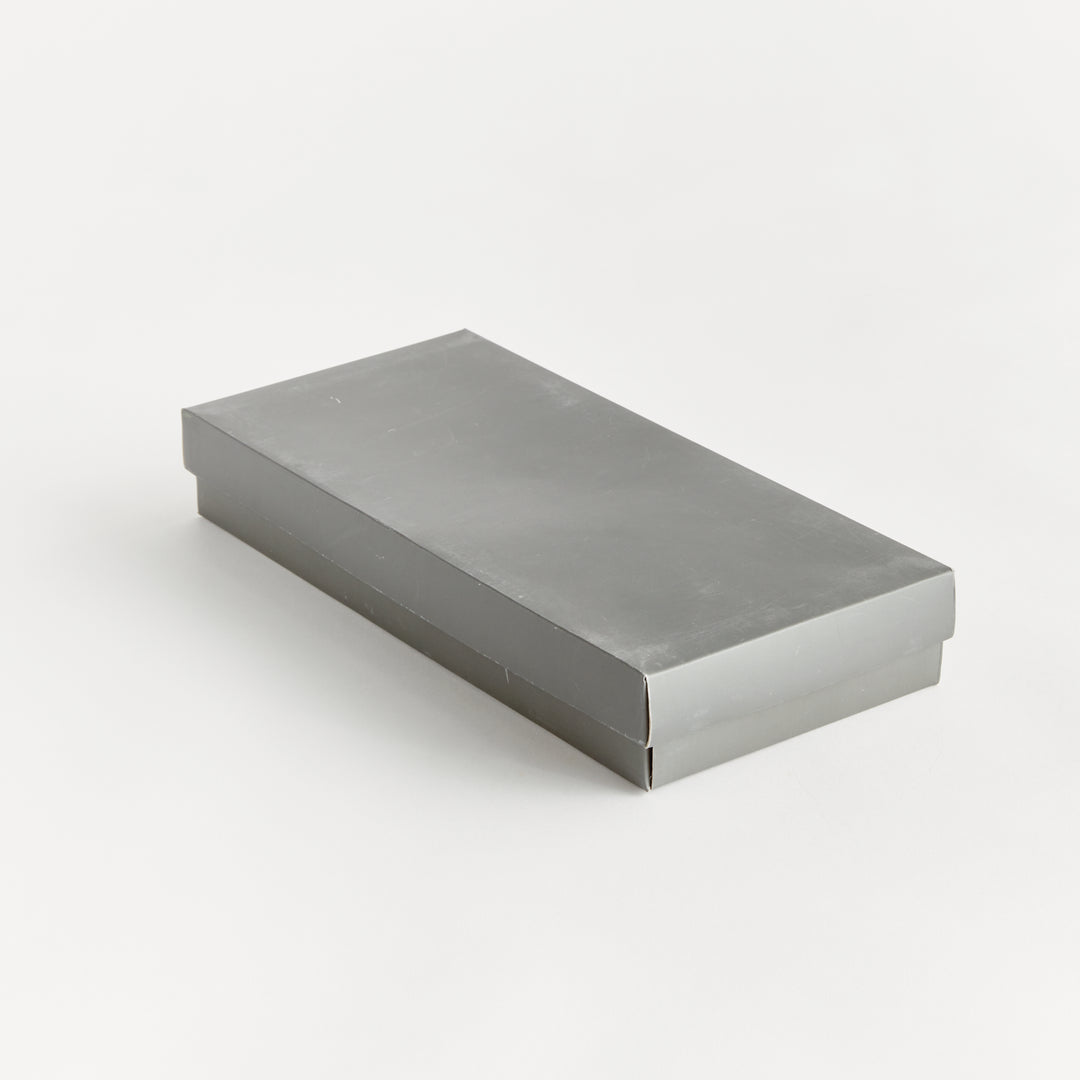 Closed gift box for bamboo barware set, shown in sleek gray packaging with coastal casual appeal.