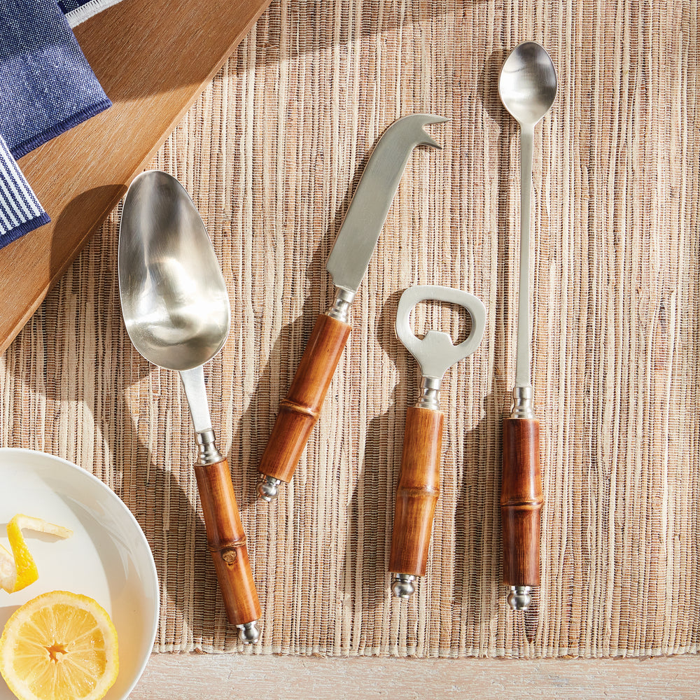 Lifestyle view of 4-piece bamboo barware set styled with citrus, evoking a coastal casual feel.