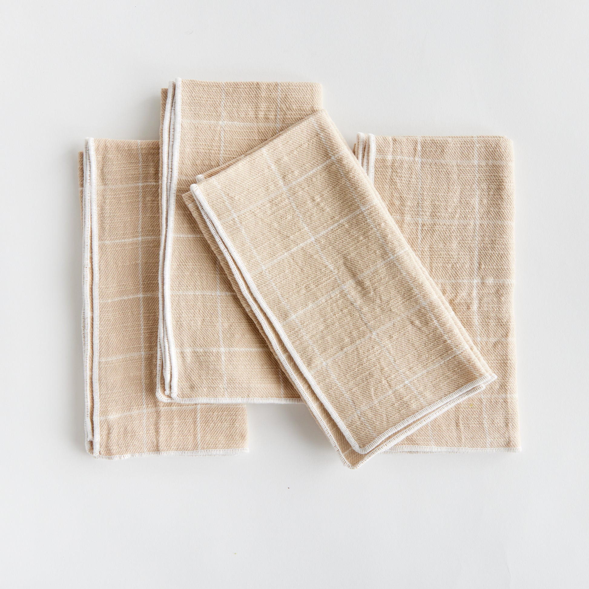 These four cotton napkins add a touch of softness to your table. The beautiful and textured soft taupe is designed to match any tablescape. Made of 100% cotton, they offer a luxurious and high-quality dining experience. The neutral taupe color seamlessly complements any table setting, enhancing both style and functionality for your meals.