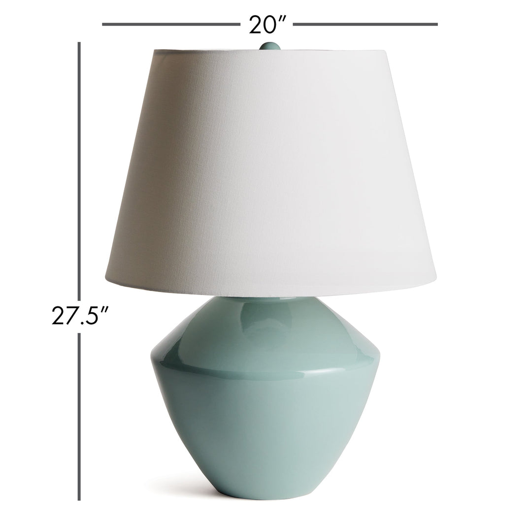 Crafted with an ancient wooden mold, the Clyde Celadon Table Lamp showcases a timeless design and stunning celadon finish. Its fabric shade adds character and charm to spaces such as family rooms, studies, and bedrooms.