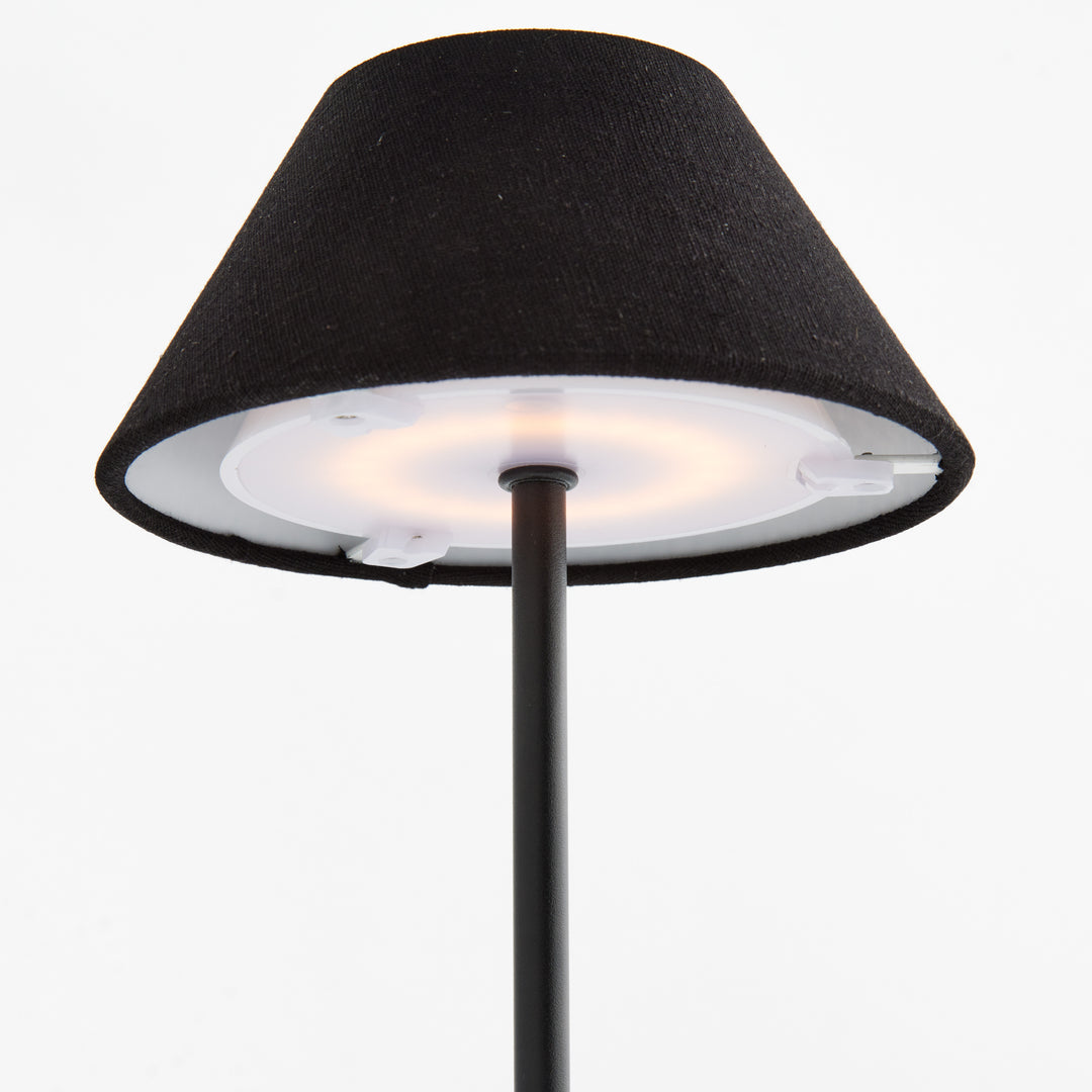 Underside detail of black cordless LED table lamp showing integrated LED light source beneath linen shade – Contemporary
