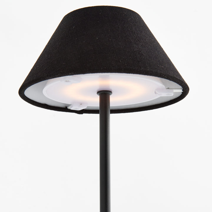 Underside detail of black cordless LED table lamp showing integrated LED light source beneath linen shade – Contemporary