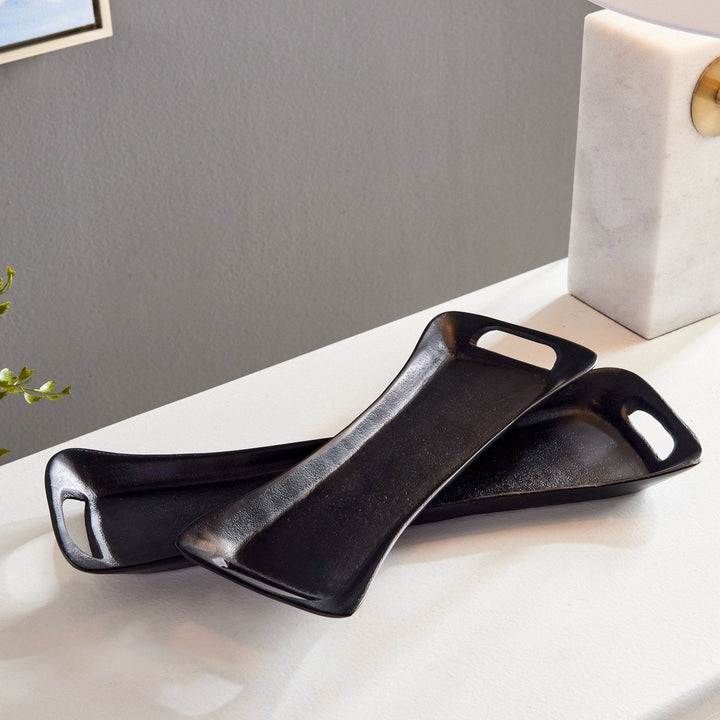 Black trays styled with marble lamp and plant on a clean white console – Urban Contemporary.

