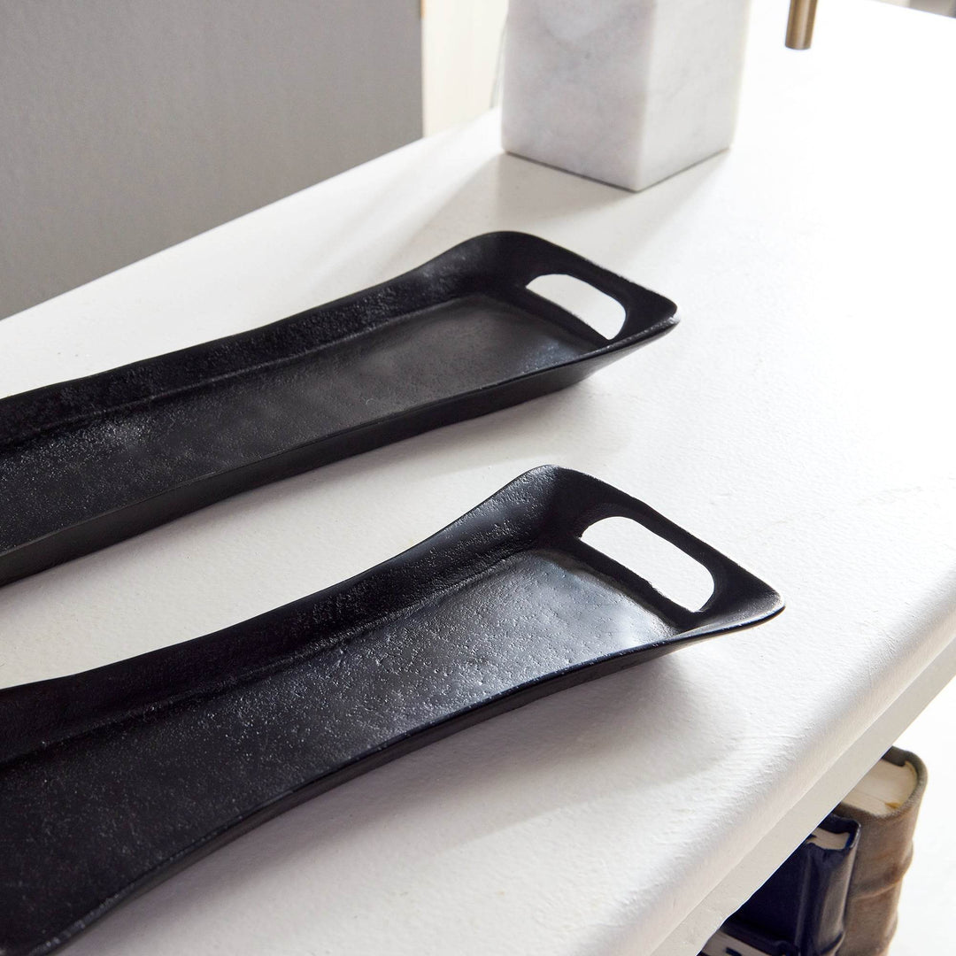 Overhead view of nested rectangular trays styled on a console table – Urban Contemporary.

