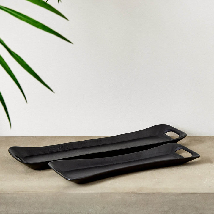 Set of two black metal trays styled on a stone console with greenery – Urban Contemporary.

