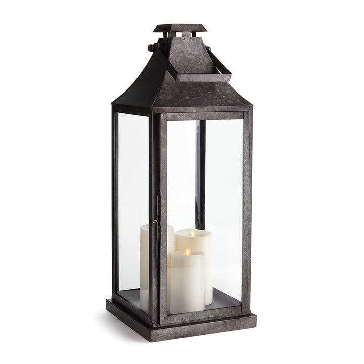 Black galvanized metal outdoor lantern with glass panels and candle interior for transitional patio decor style