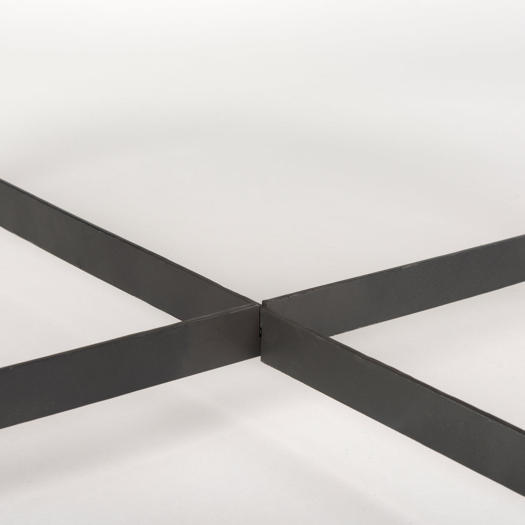 Close-up of black iron cross-bar support beneath the round coffee table – Modern Organic