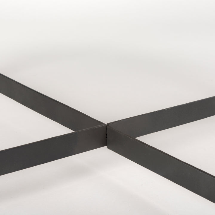 Close-up of black iron cross-bar support beneath the round coffee table – Modern Organic