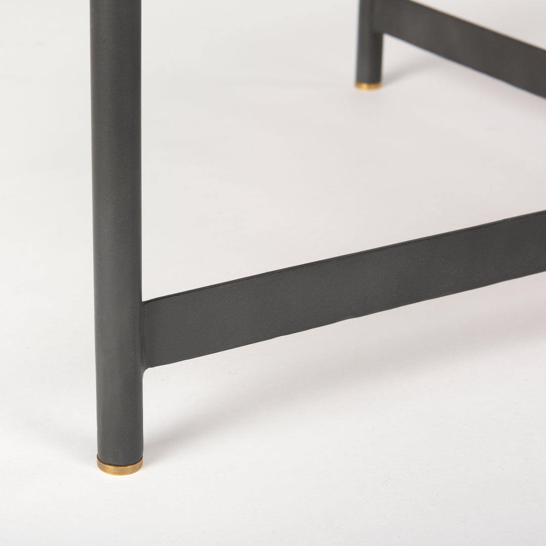 Close-up of black iron table leg with gold metal cap and clean architectural profile – Modern Organic