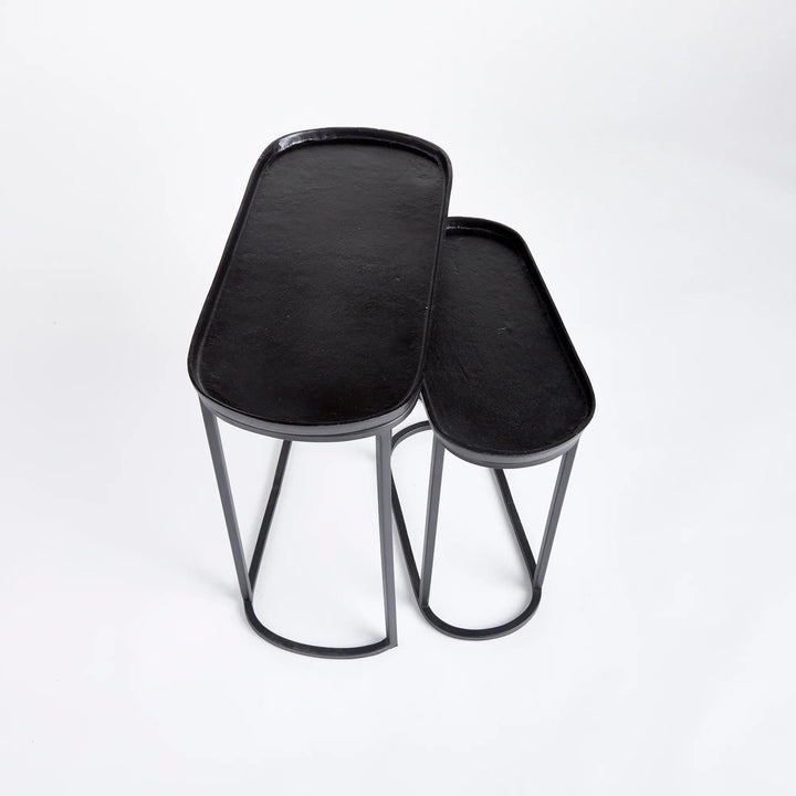 Black metal nesting end tables with tray tops shown at angle, slim modern side tables with space-saving design – Modern