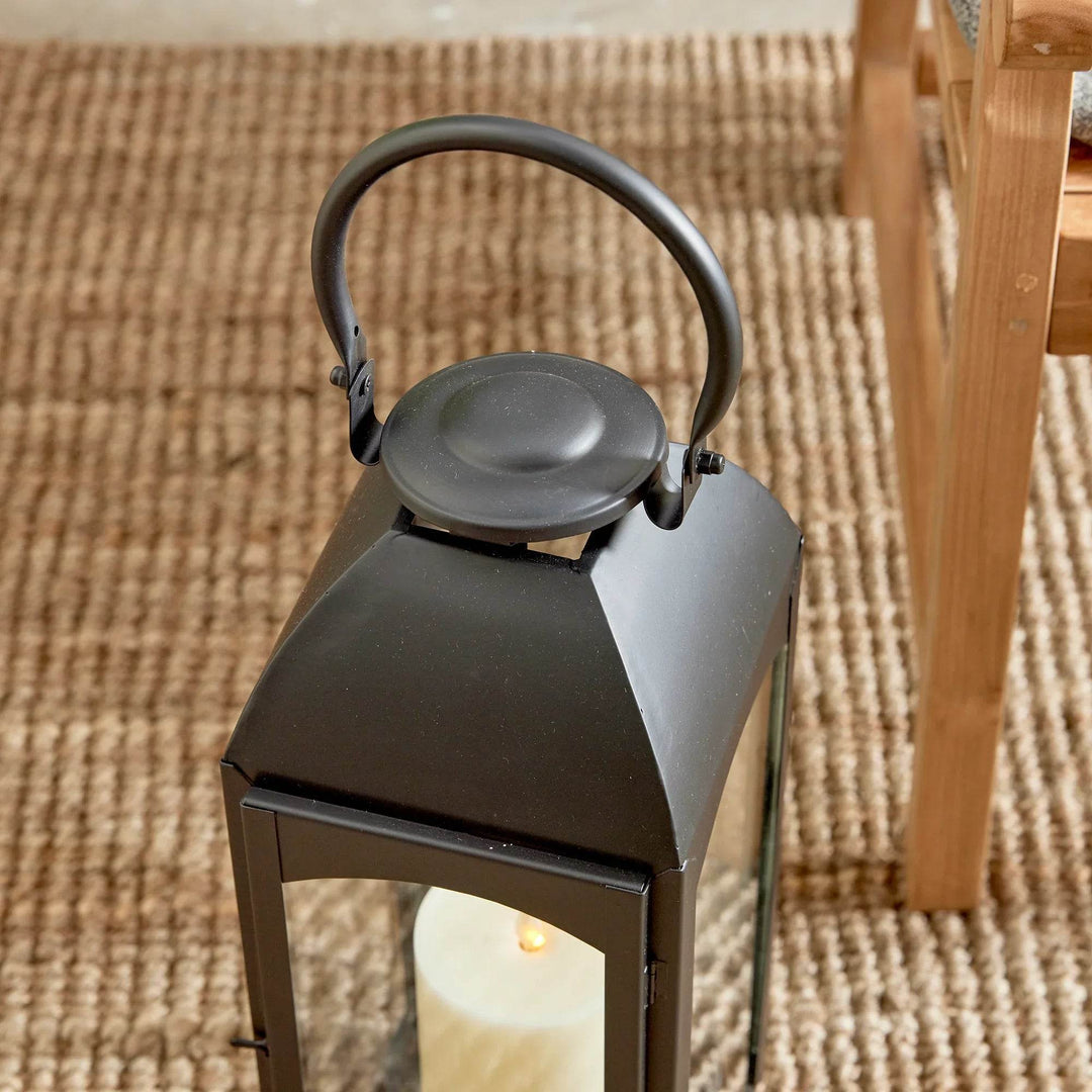 Close-up of lantern cap and handle with smooth powder-coated finish and hardware joints; clear glass beneath – Transitional Garden and Outdoor