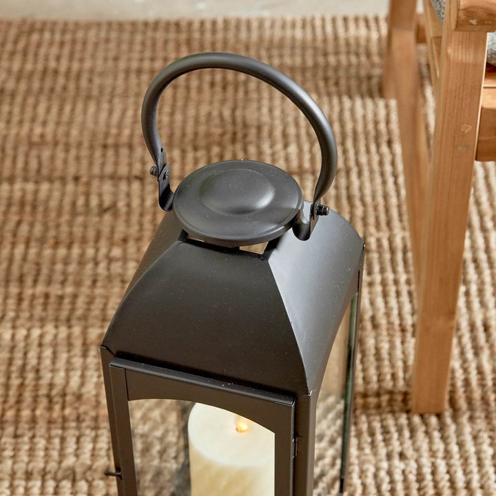 Close-up of lantern cap and handle with smooth powder-coated finish and hardware joints; clear glass beneath – Transitional Garden and Outdoor