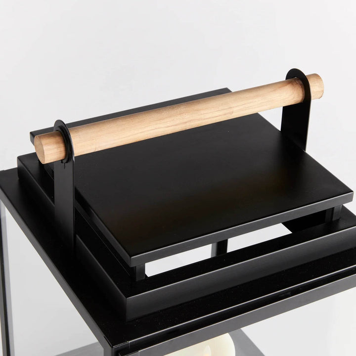 Top view of large black outdoor lantern with teak handle, square stainless steel frame and wide glass panels – Modern Farmhouse.