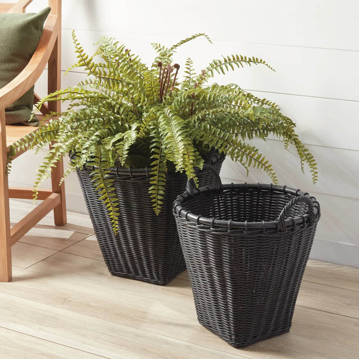 Black rattan basket as plant cover with fern; tapered silhouette and bound rim shown in a styled vignette – Modern Boho.