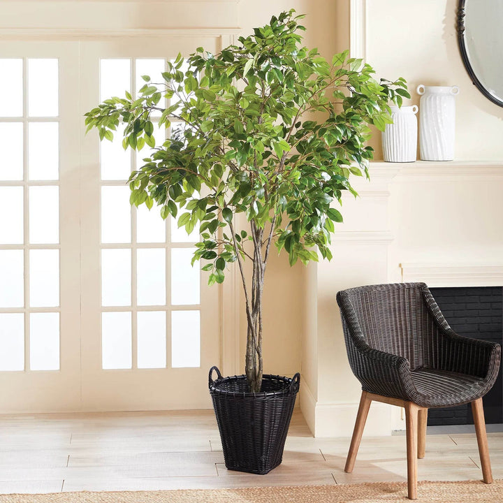 Large black rattan basket beside indoor plant; tapered form and wrapped handles add texture and utility daily – Modern Boho.