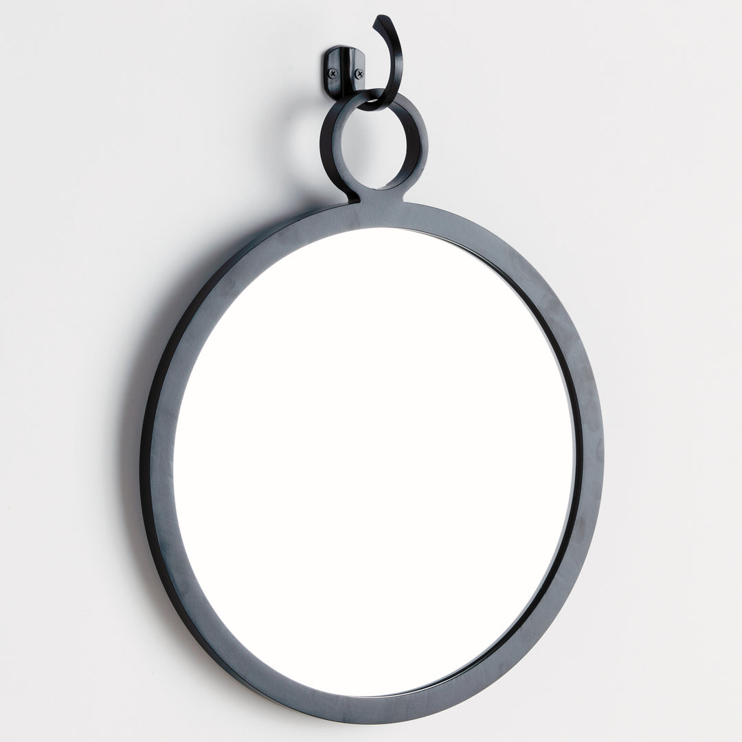 Angled view of matte black round mirror with elevated hook mount, modern minimalist interior styling