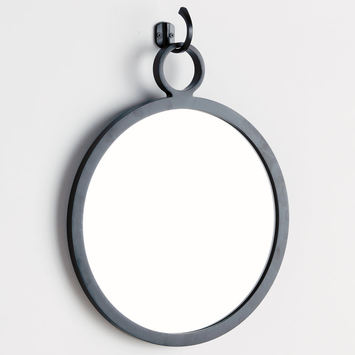 Angled view of matte black round mirror with elevated hook mount, modern minimalist interior styling