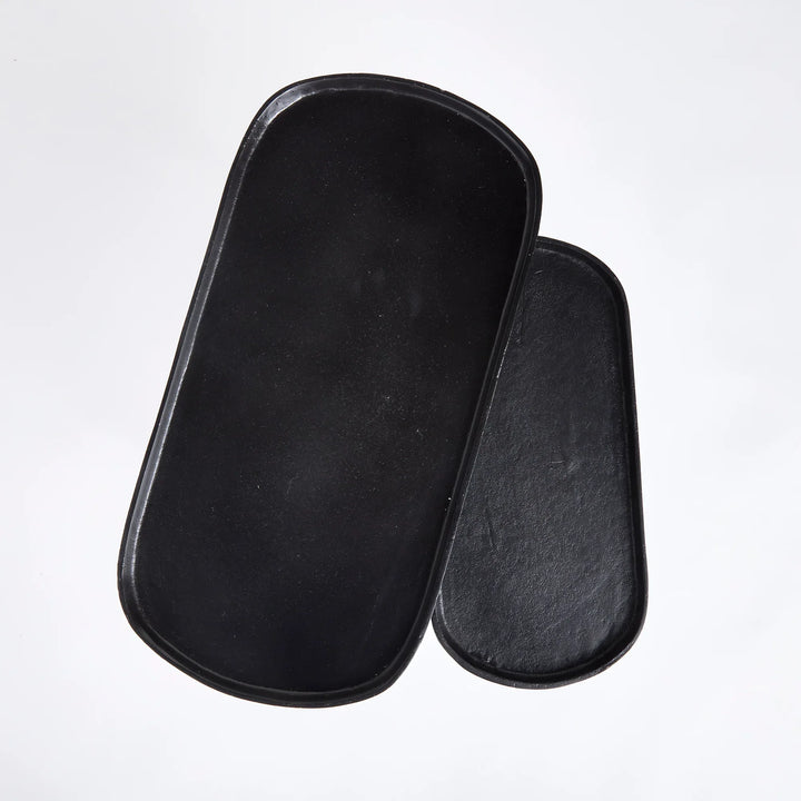 Black metal nesting end tables with tray-style tops, top view showing rounded edges and functional surface design – Modern