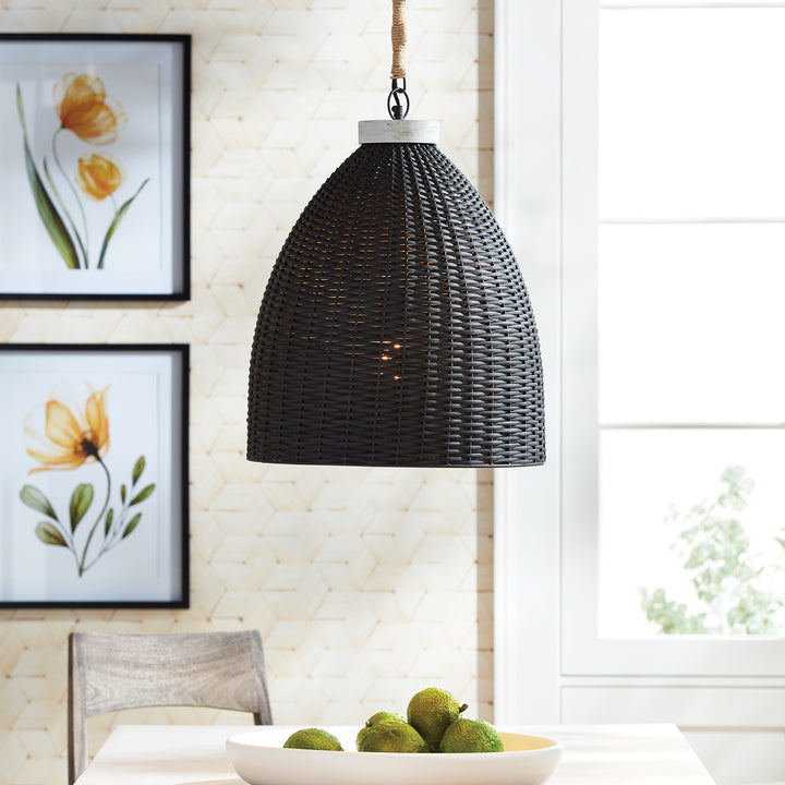 Blackwashed woven rattan pendant above a pale kitchen counter, with botanical wall art and bright window, Transitional style