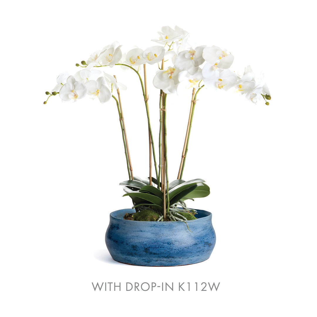Blue ceramic decorative bowl styled with white orchid drop-in arrangement, perfect for layered tabletop displays – Coastal Transitional.