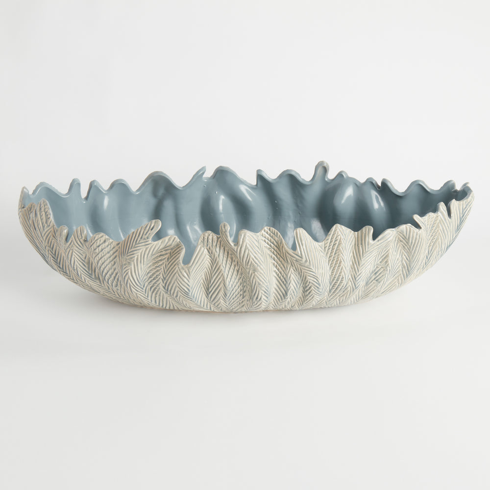 Top view of large blue ceramic decorative oval bowl with glossy reactive glaze and sculpted organic shape, styled as tabletop centerpiece – Modern Organic.