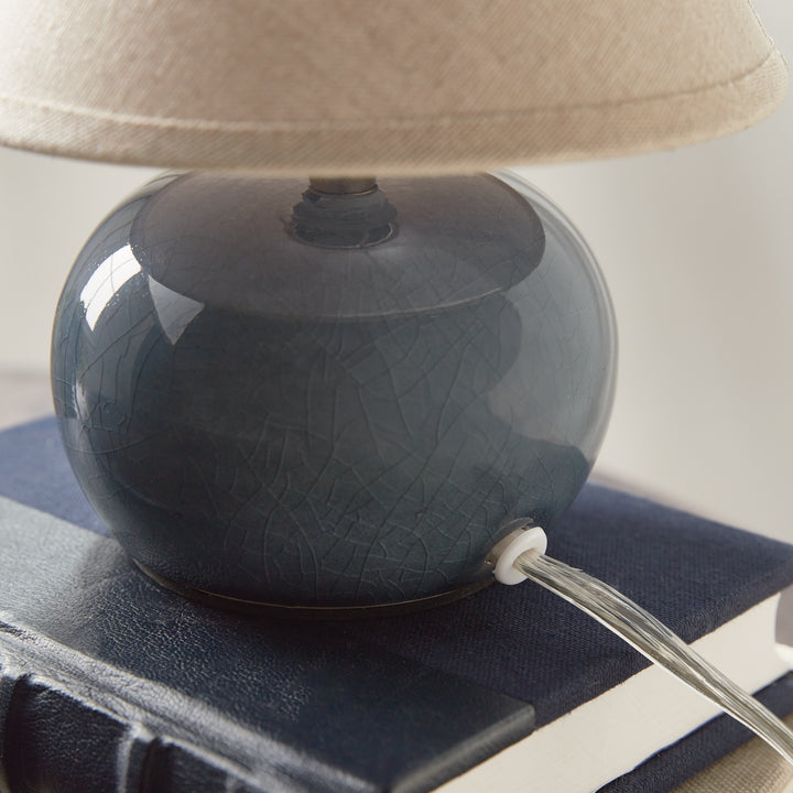 Blue ceramic mini table lamp rear close-up showing crackle glaze and the clear lamp cord at its base - Coastal Transitional