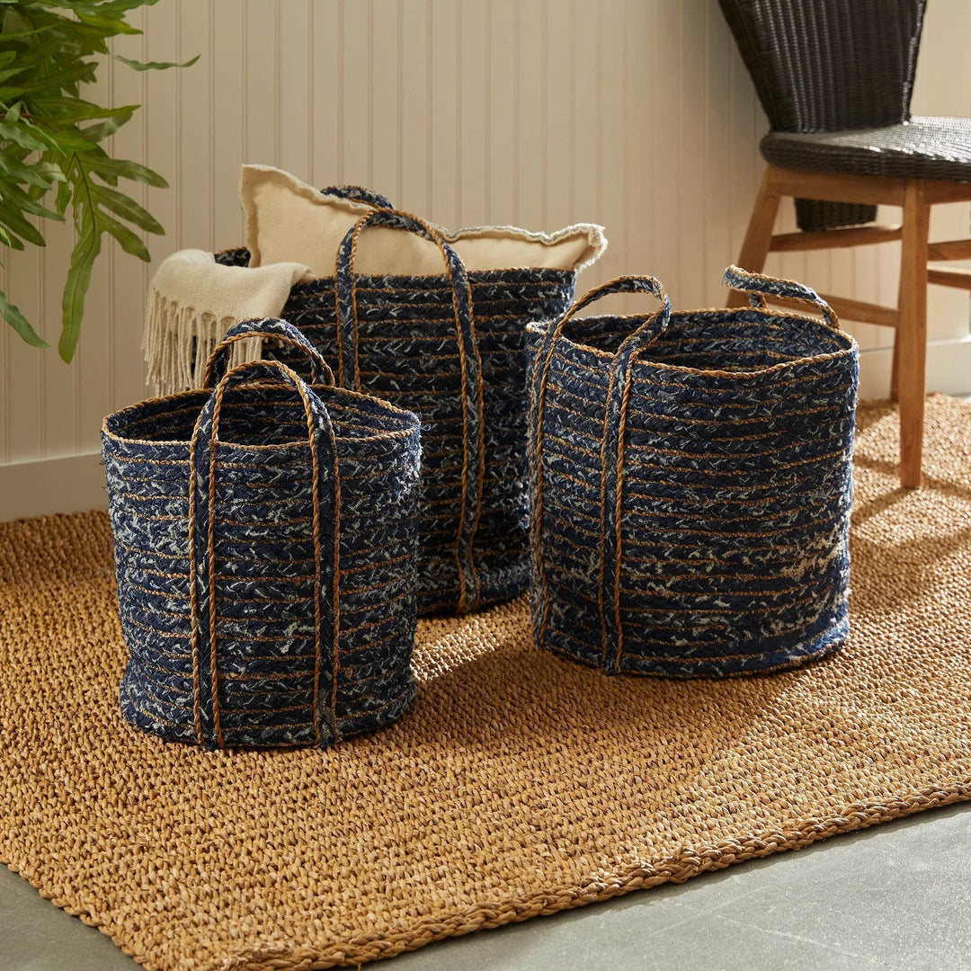 Recycled denim and seagrass baskets used for soft storage beside a woven rug
