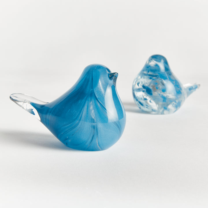 Blue glass bird sculptures set of two with hand blown detailing, compact decorative accents for shelves and tabletops.