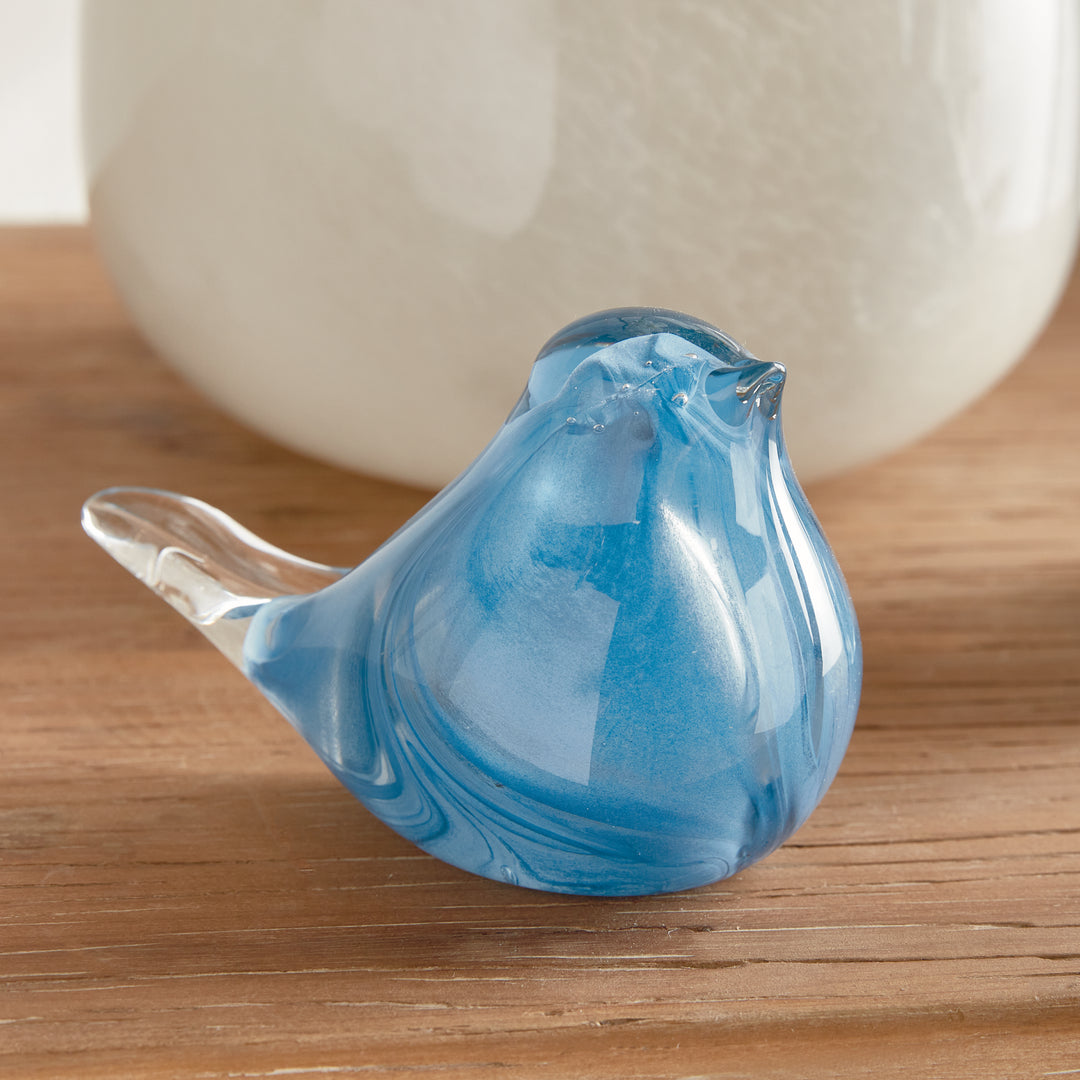 Side view of hand blown blue glass finch sculpture showing sculptural bird silhouette and smooth glass finish.