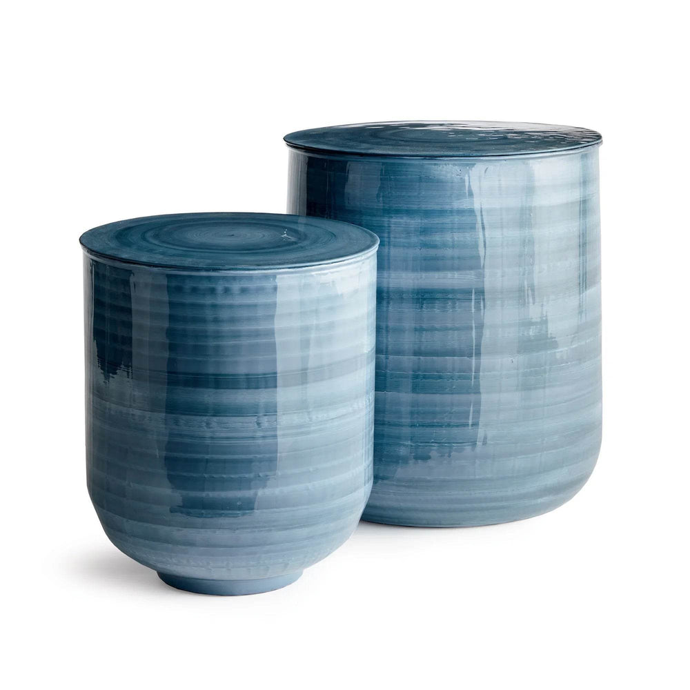 Angled view of two enameled iron storage tables in blue gray finish, showing coastal hand-painted brushwork – Coastal