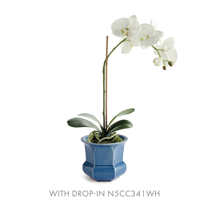 Blue faceted ceramic planter paired with a white orchid drop-in, showing its flared rim and rounded lower body, Traditional