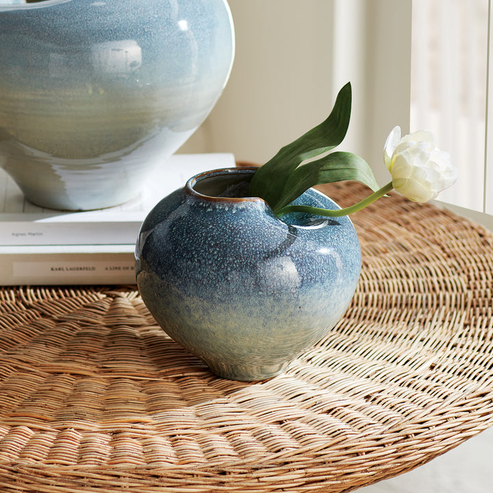 Handcrafted blue reactive glaze stoneware vase styled on a woven surface with decorative accents – Modern Organic