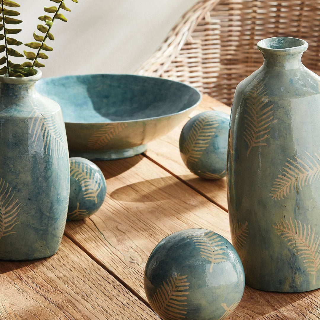 Tall decorative vase shown with matching bowl and accents in a soft neutral room