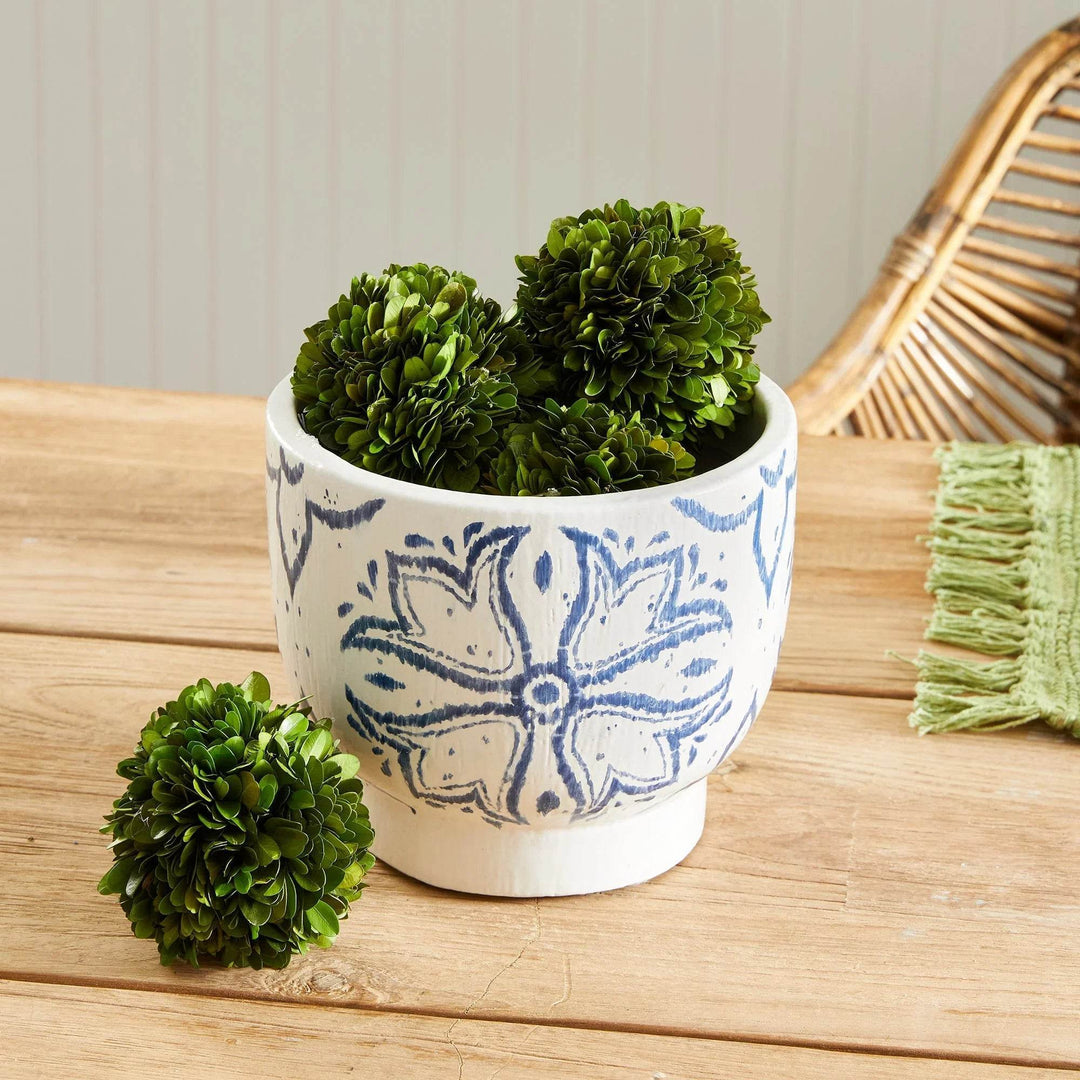 Blue and white ceramic cachepot planter in casual coastal styled setting with green accents and wood tones – Coastal Casual.

