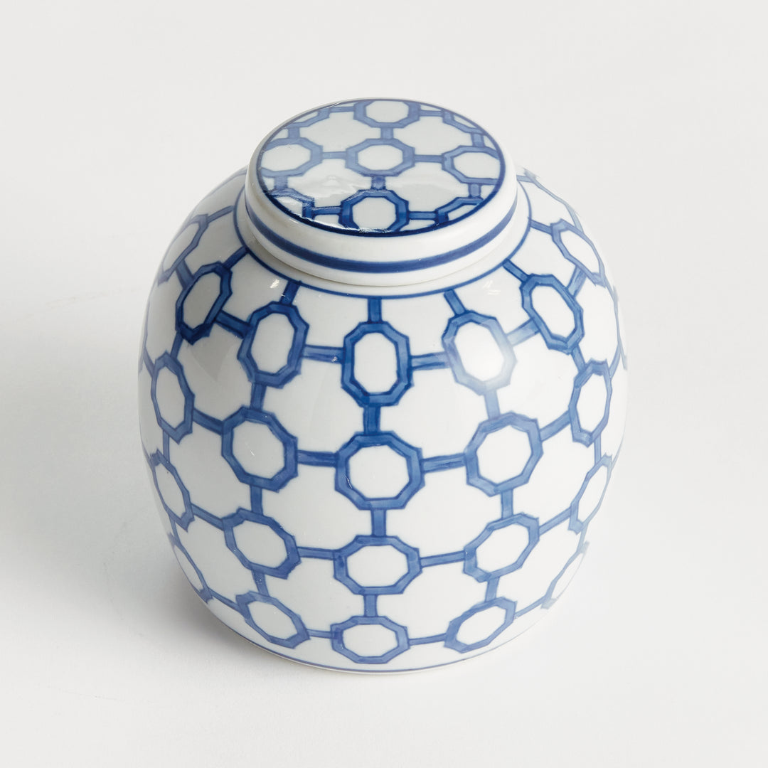 Angled view of blue and white ceramic ginger jar with fitted lid and geometric link pattern, small decorative accent – Coastal.