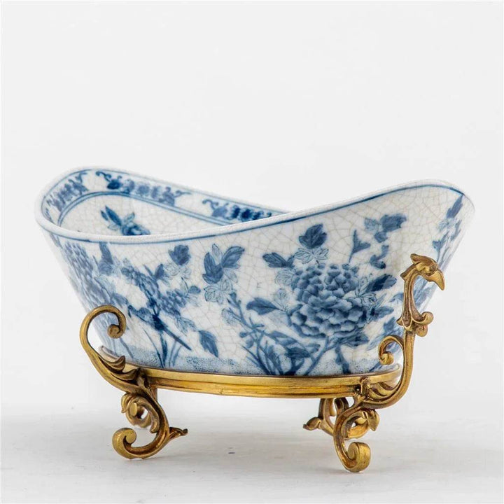 Blue and white porcelain decorative bowl with bronze ormolu base, angled front view

