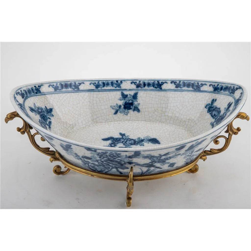Blue and white porcelain decorative bowl with bronze ormolu base, side view.