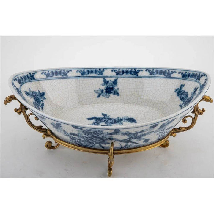 Blue and white porcelain decorative bowl with bronze ormolu base, side view.