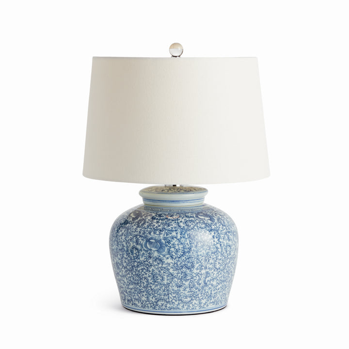 Blue and white porcelain table lamp with linen shade and crystal finial, full front view on white background – Transitional style.