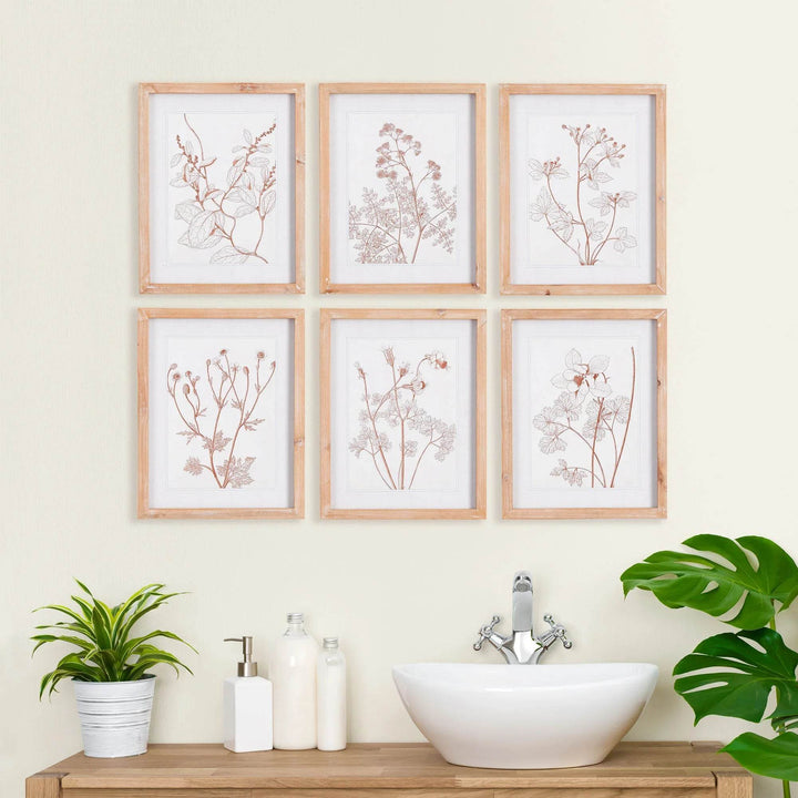 Minimalist blush botanical art set styled above a bathroom vanity with natural decor
