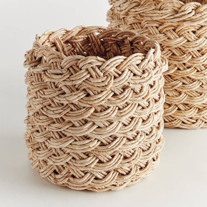 Round abaca French braid baskets placed on floor beside furniture, styled as casual storage accents – Boho Storage Baskets