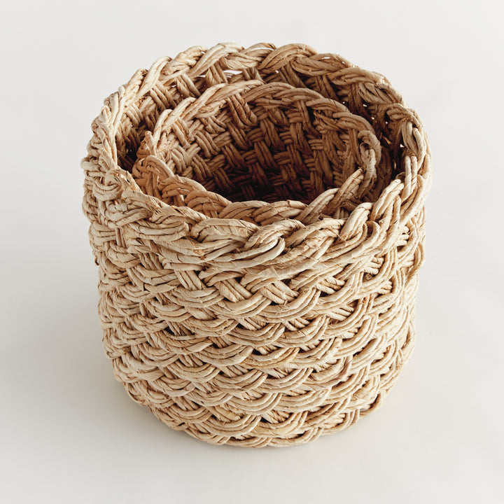 Set of 2 round abaca baskets, one nested inside the other, highlighting natural tan fiber and braided weave – Boho Decorative Baskets