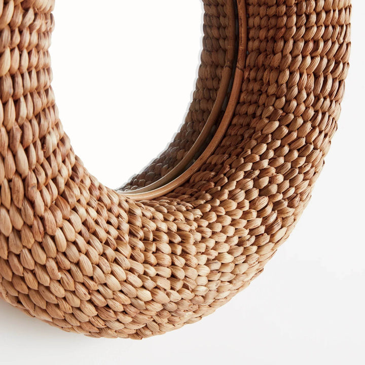 Close-up detail of natural fiber round mirror frame showcasing boho texture and artisan craftsmanship.