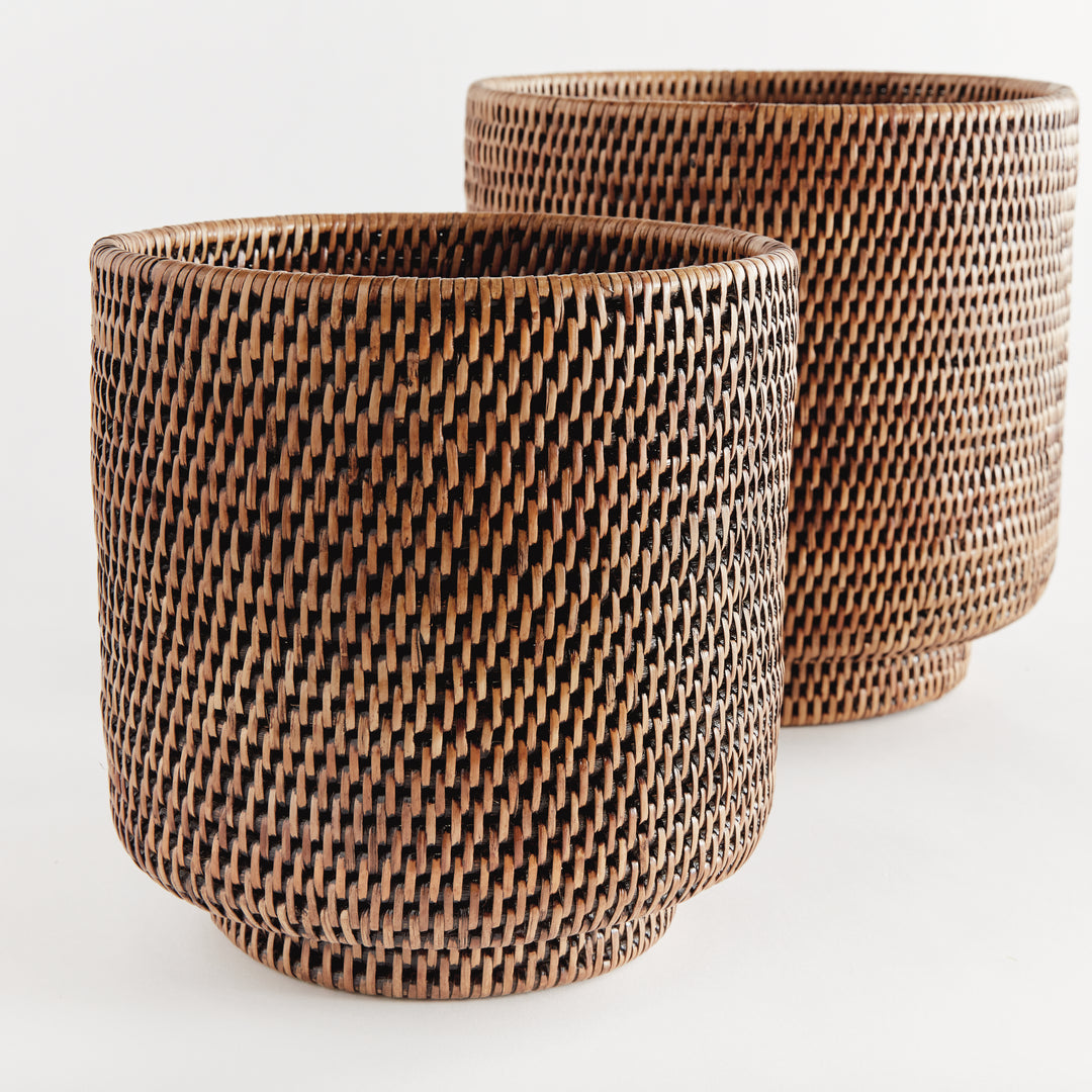 Brown rattan cachepot set close-up showing tight woven sides, rounded rims and raised circular feet - Coastal Transitional