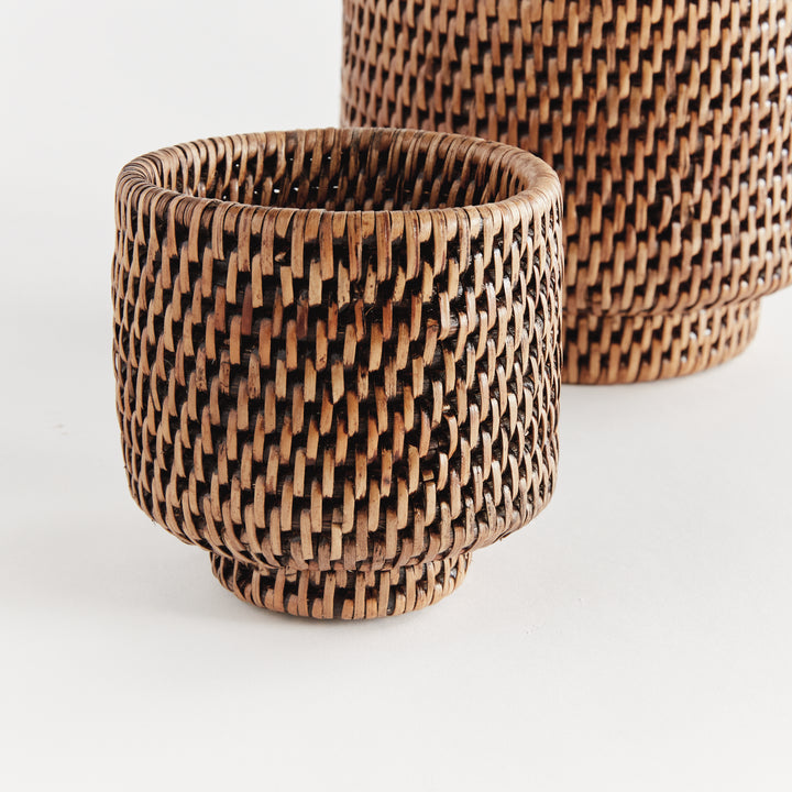 Brown rattan cachepot set close-up showing tight woven sides, rounded rims and raised circular feet - Coastal Transitional
