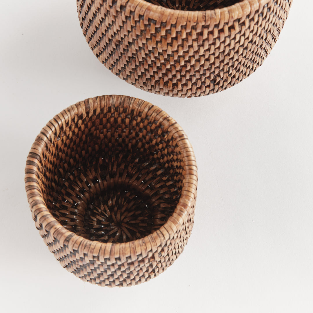 Brown rattan cachepots viewed from above, showing woven interiors and the circular pattern in the base - Coastal Transitional