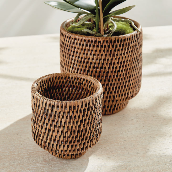 Brown rattan cachepots close-up with one open pot beside an orchid arrangement in the larger woven pot - Coastal Transitional