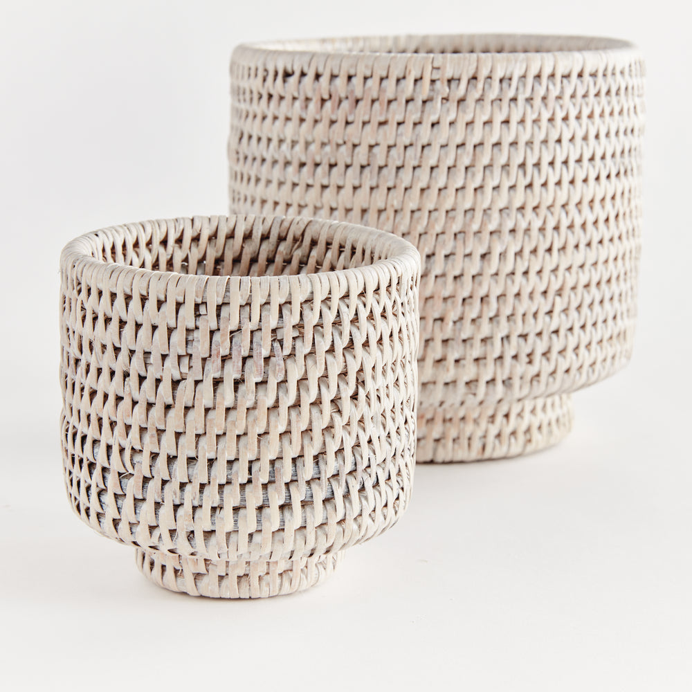 Whitewash rattan cachepot set close-up showing woven sides, rounded rims and raised circular feet - Coastal Transitional