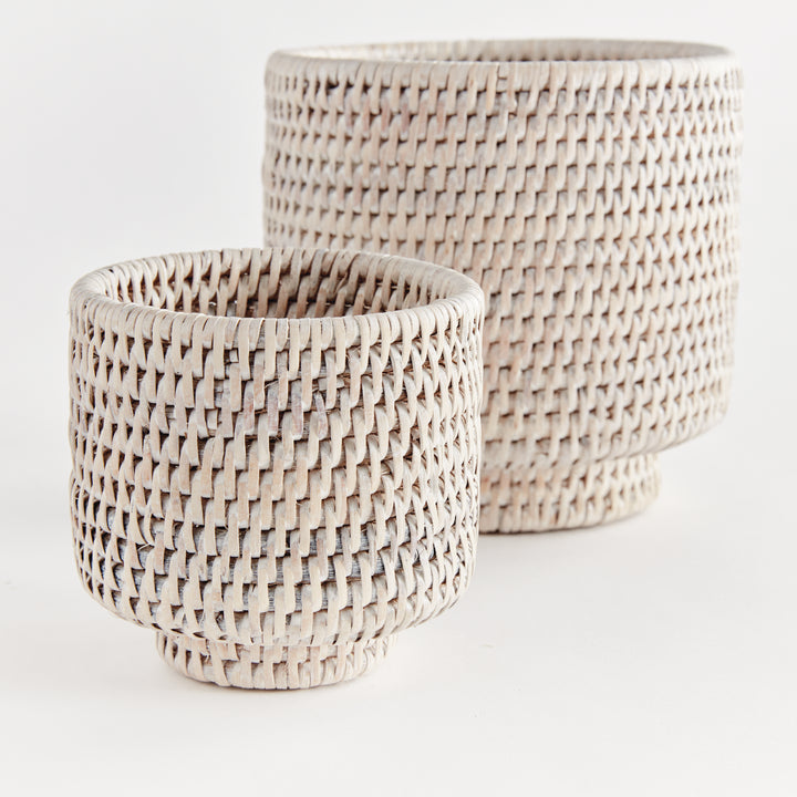 Whitewash rattan cachepot set close-up showing woven sides, rounded rims and raised circular feet - Coastal Transitional