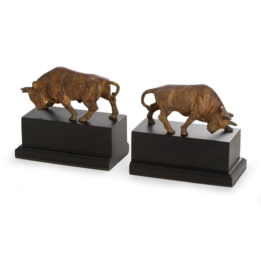 Pair of sculptural brass bull bookends with flamed patina finish on black wood bases, 6.75 inches tall, shown from front angle – Decorative Sculptural.